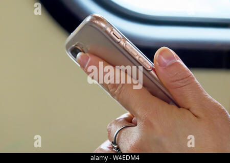 A young woman`s hand holding a smart phone. Stock Photo